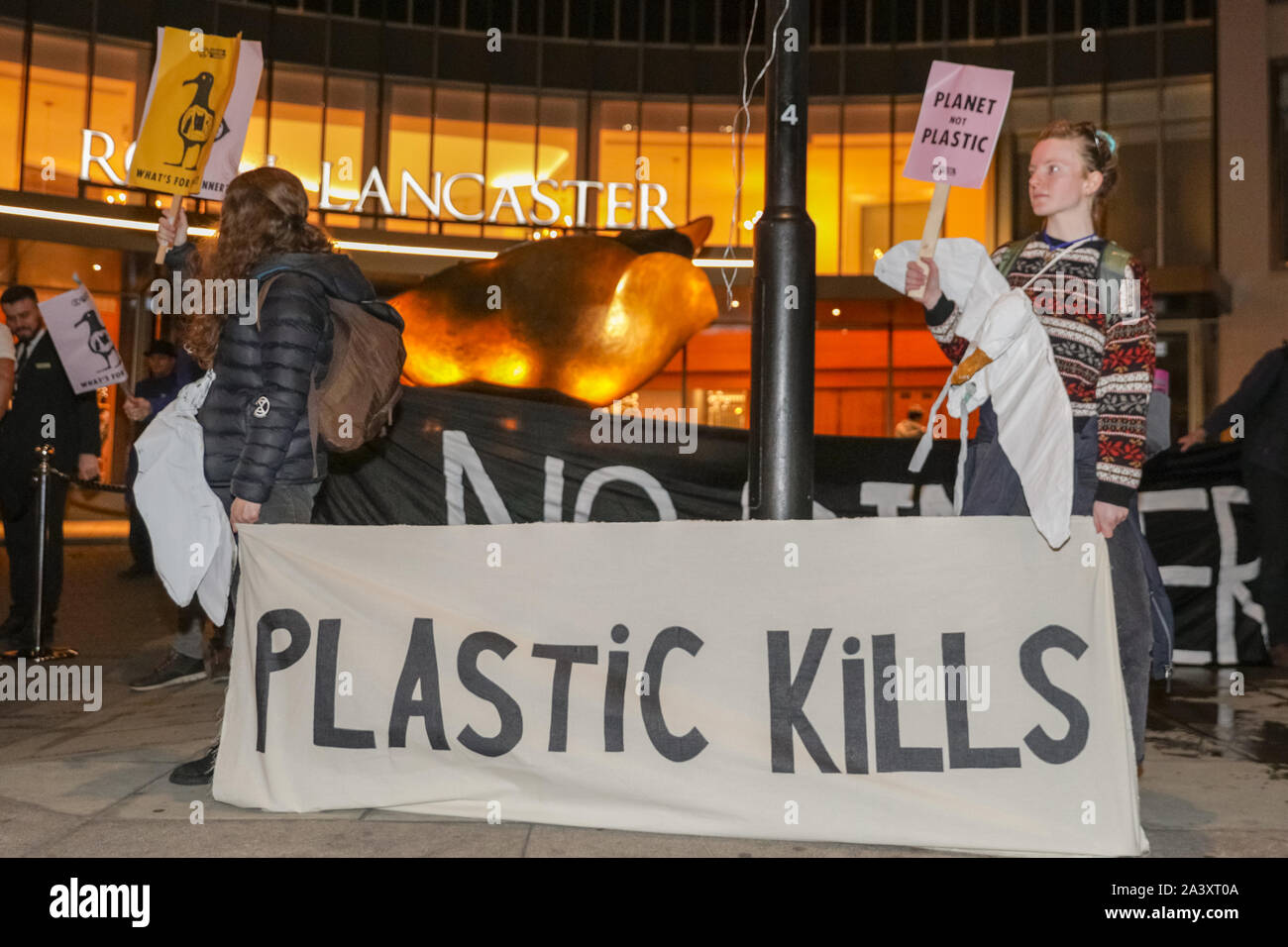 London, UK, 10 Oct 2019. Extinction Rebellion protesters from London XR groups, including the XR drummers, protest outside the British Plastics Federation (BPF) annual dinner at the Royal Lancaster Hotel this evening. The event is an annual industry and networking event for the plastics industry. Many of the attendees interact and chat to protesters on this occasion. Credit: Imageplotter/Alamy Live News Stock Photo