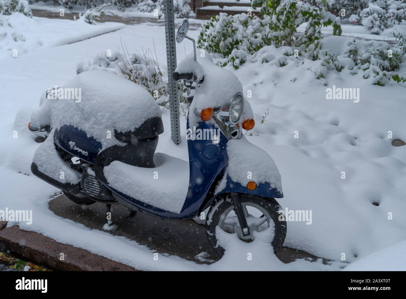 Denver, Colorado, USA- October 10, 2019: Scooter covered in snow during Denver's first snow storm of the season. Stock Photo