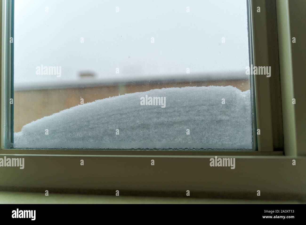 Window with snow accumulated on the lower part Stock Photo