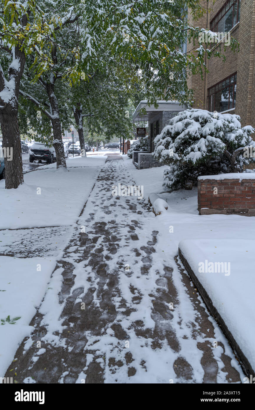 Denver, Colorado, USA- October 10, 2019: snow covered side walk during Denver's first snow storm of the season. Stock Photo