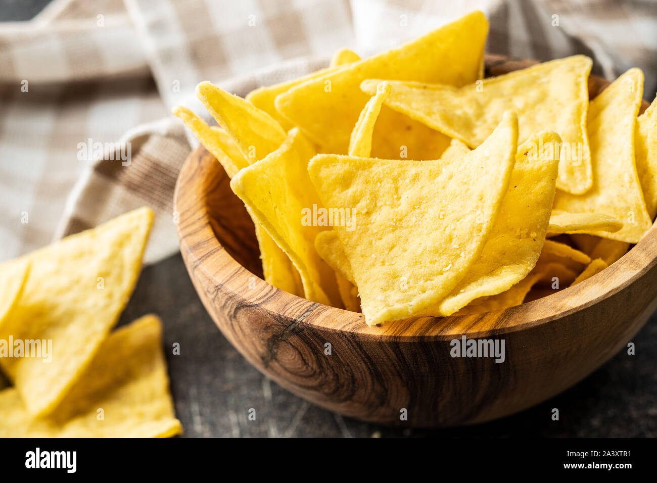 Corn nacho chips. Yellow tortilla chips in wooden bowl Stock Photo Alamy