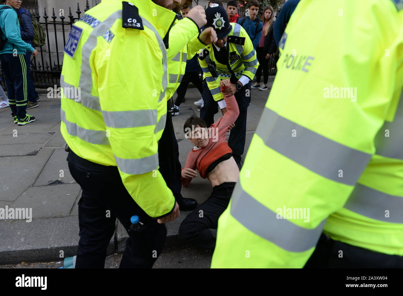 Demonstrator being moved during the Extinction Rebellion demonstration in London Stock Photo