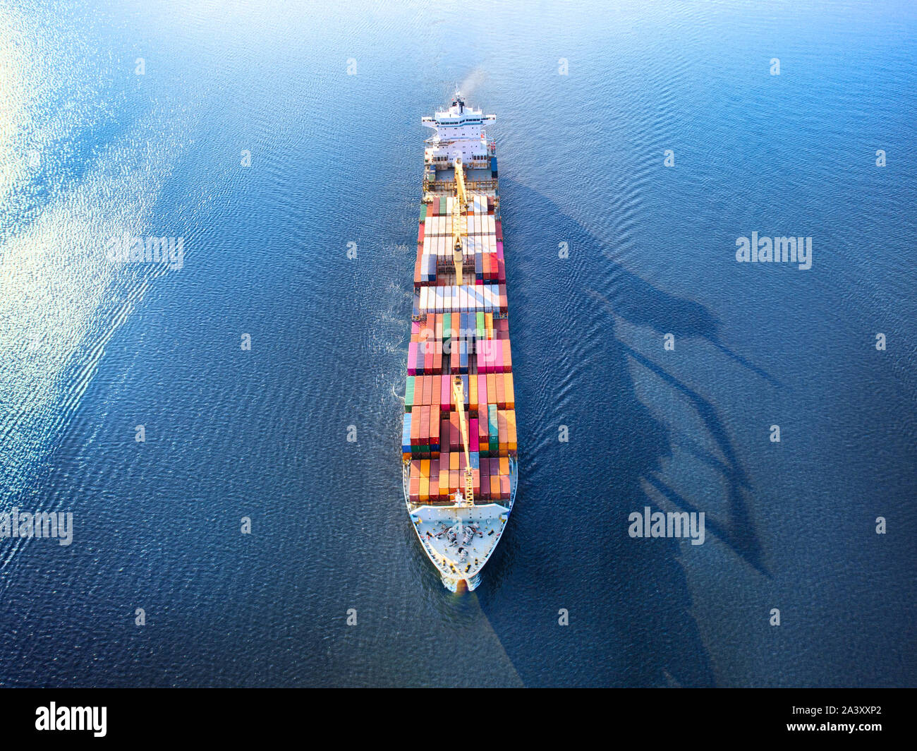 Large full loaded container ship sailing high seas. Aerial front view, hdr image Stock Photo