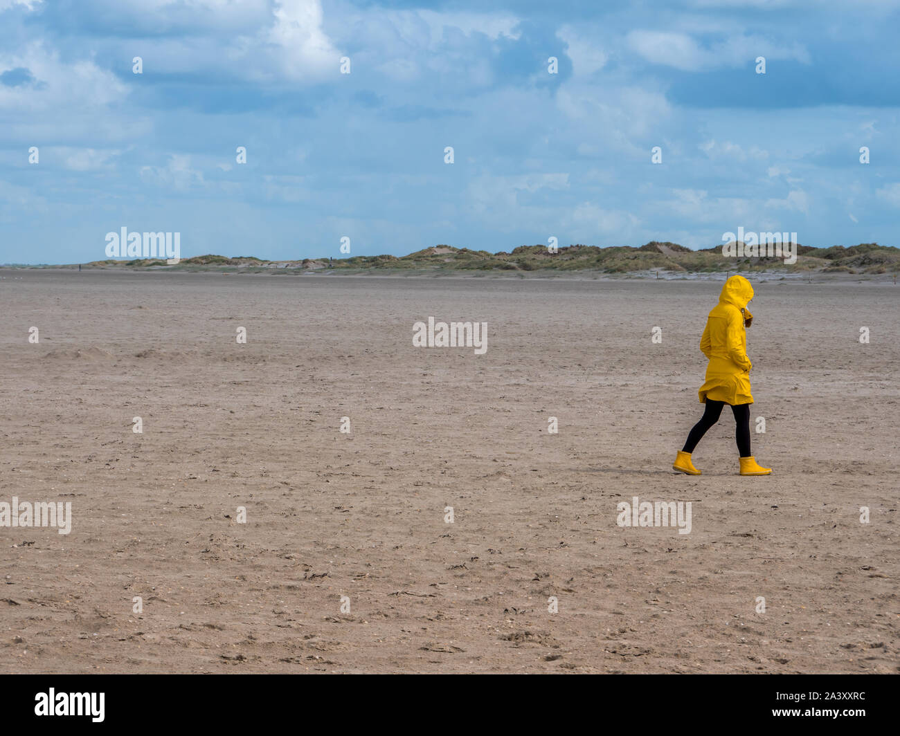Woman with yellow raincoat hi-res stock photography and images - Alamy