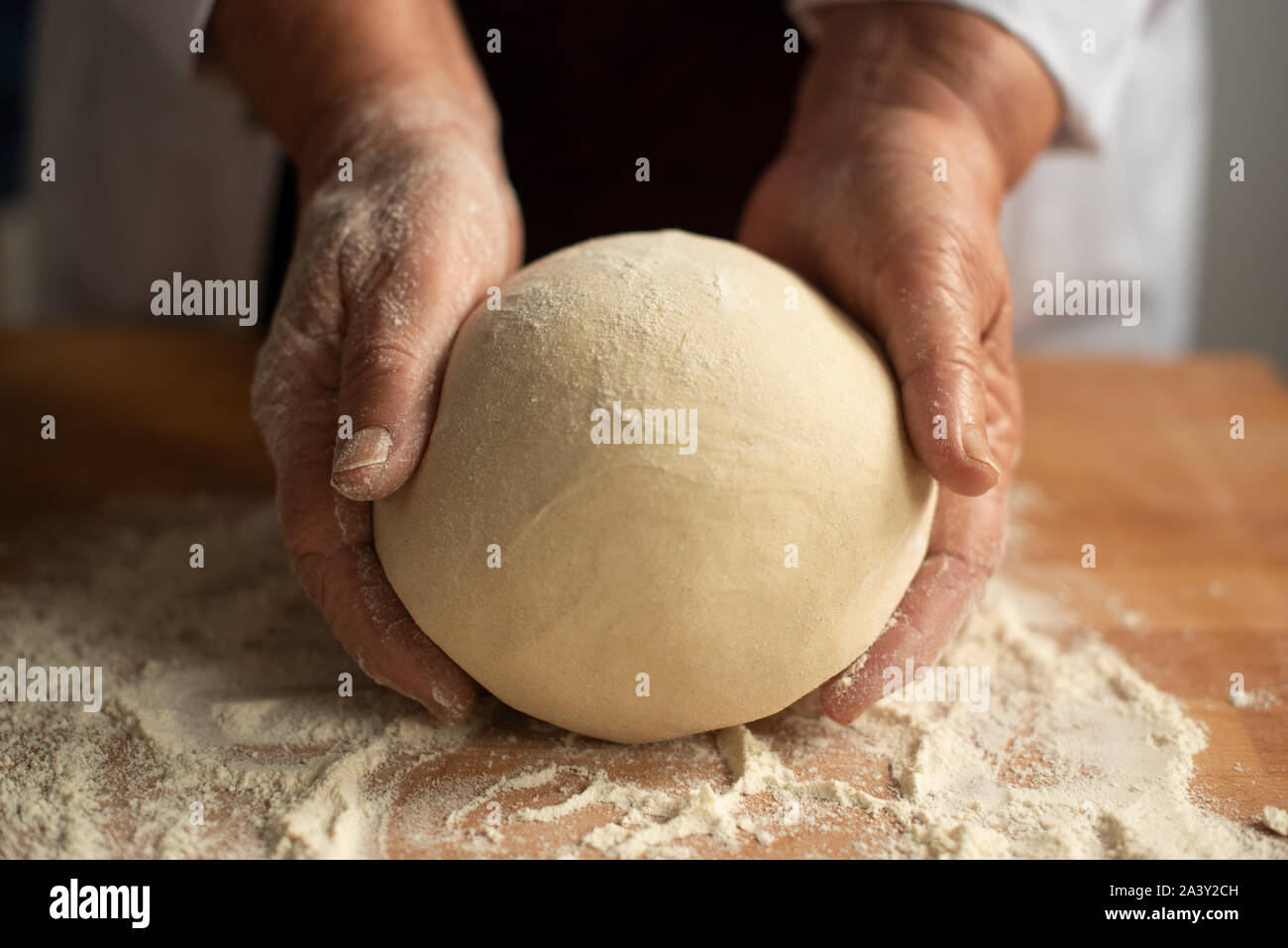 Artisan baker kneading sourdough bread- close-up Stock Photo
