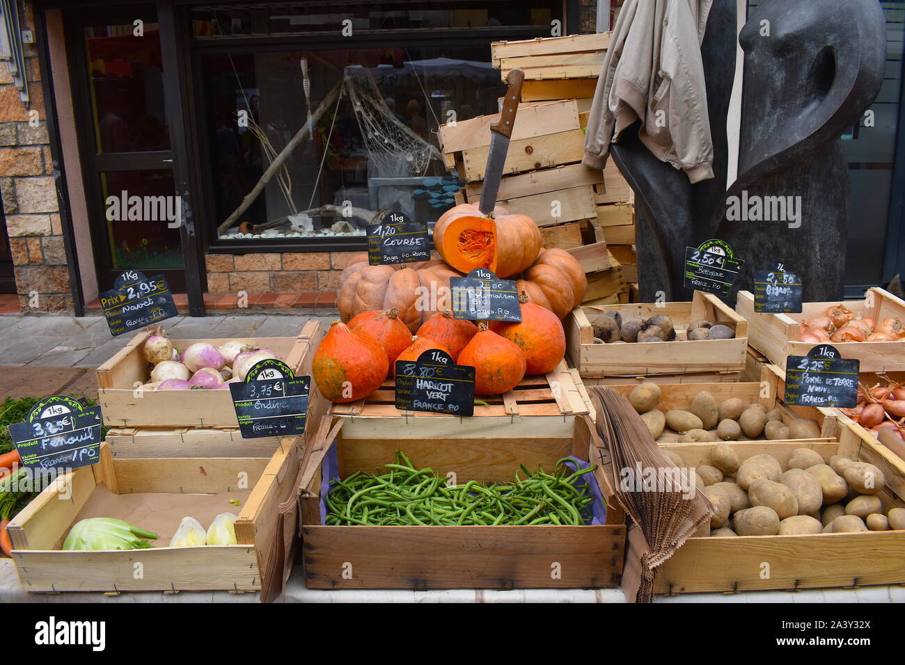 Organic seasonal vegetables for sale on a local European market. Pumpkin, potatoes, green beans, swede, beetroot, onion, shallots, carrots and fennel. Stock Photo