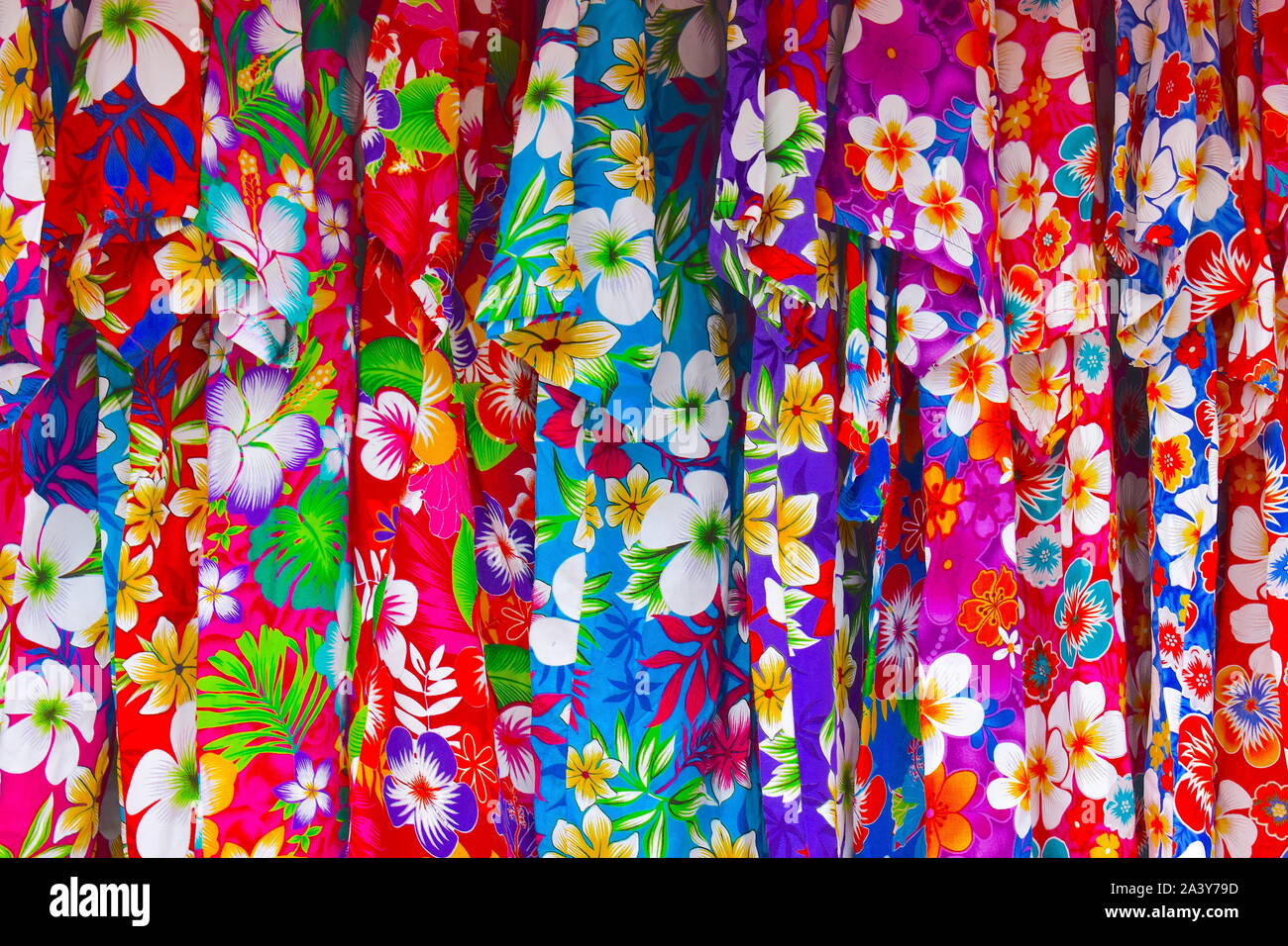 Hawaiian flower print shirts on sale. Different colours and sizes for the entire family available on the local market stalls. South of France, Europe Stock Photo
