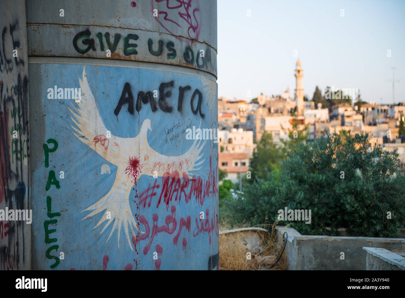 Drawing of a white dove on the Palestinian barrier with view of  Bethlehem, Palestine Stock Photo