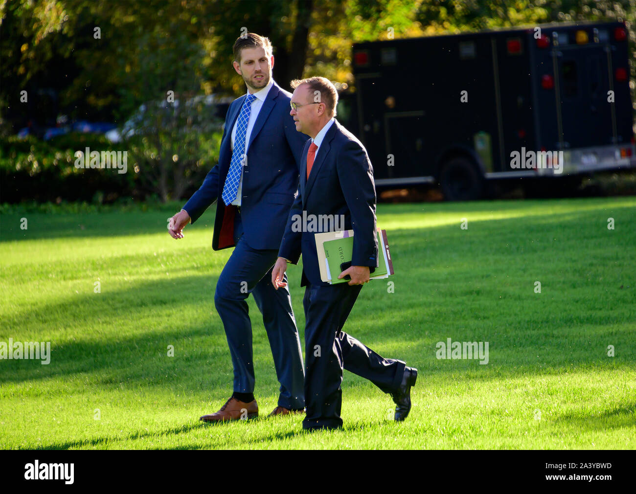 Eric Trump, left, and Acting White House Chief of Staff Mick Mulvaney, right, walk across the South Lawn to accompany United States President Donald J. Trump as he prepares to depart the White House in Washington, DC to deliver remarks at a Keep America Great Rally in Minneapolis, Minnesota on Thursday, October 10, 2019.Credit: Ron Sachs/CNP | usage worldwide Stock Photo