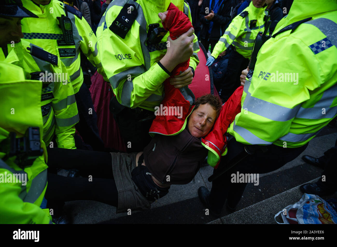 a woman is being arrested from officers Stock Photo