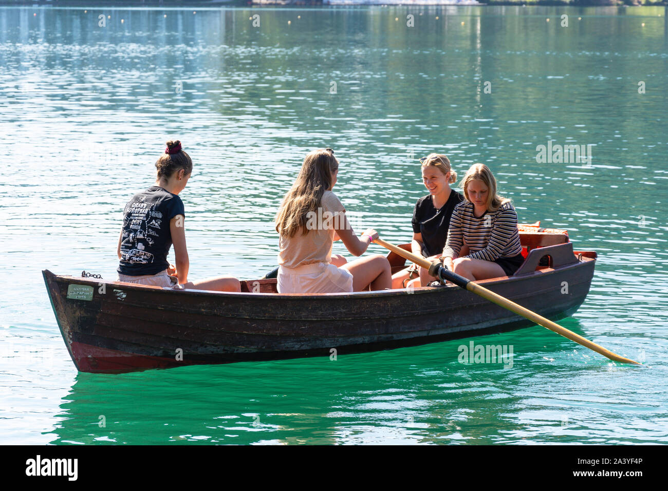 Young women in rowing boat on Lake Bled, Bled, Upper Carniola Region, Slovenia Stock Photo