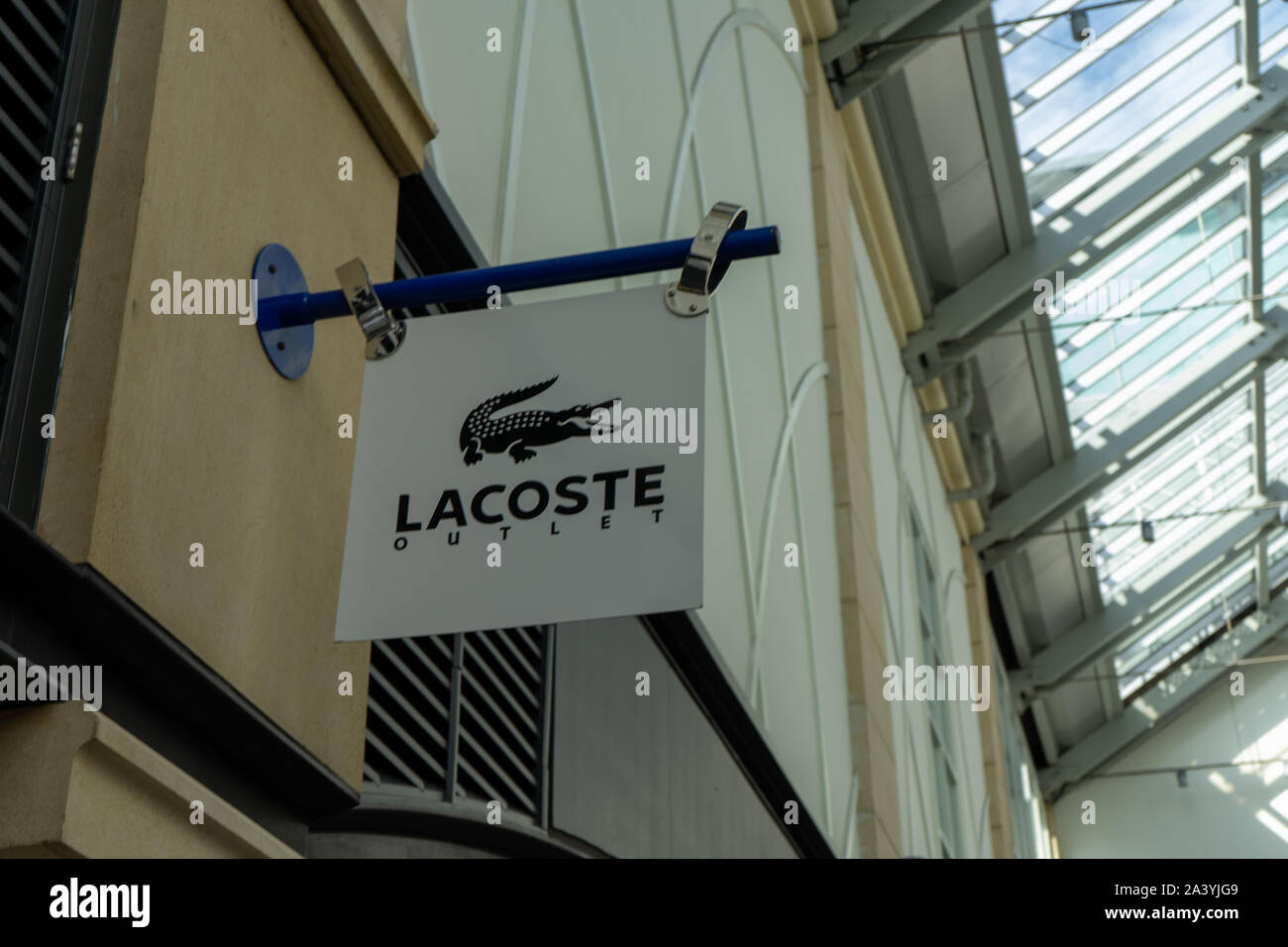 A Lacoste store sign hanging in a shopping mall Stock Photo