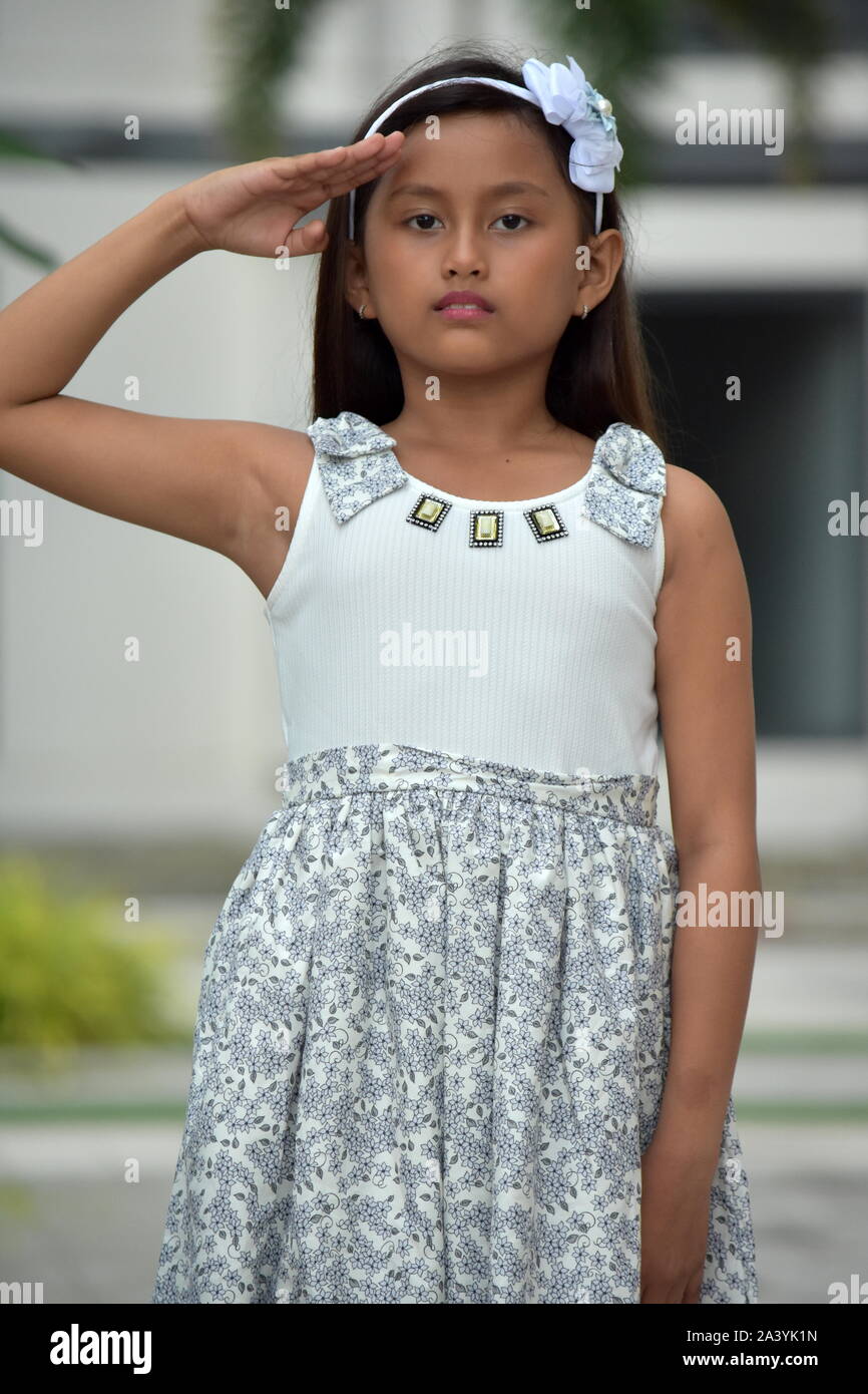 Petite Asian Girl Saluting Stock Photo