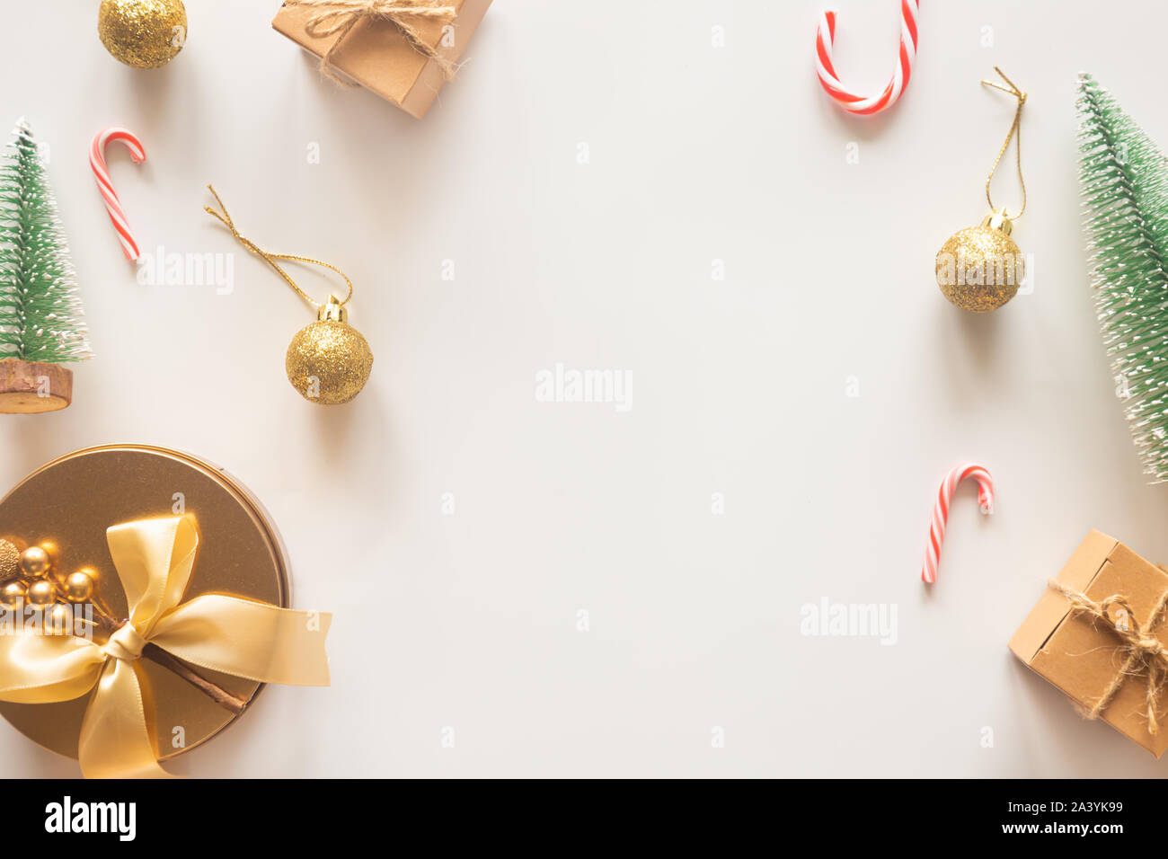 Holiday Christmas card background with festive decoration ball, stars, snowflakes, gift box, pine cones on a white background from Flat lay, top view. Stock Photo