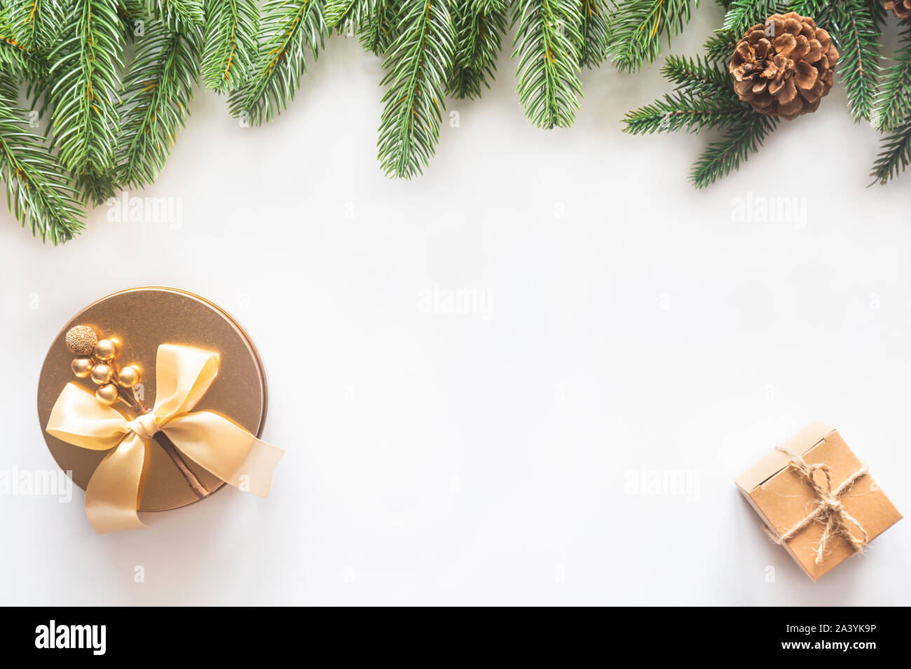 Holiday Christmas card background with festive decoration ball, stars, snowflakes, gift box, pine cones on a white background from Flat lay, top view. Stock Photo