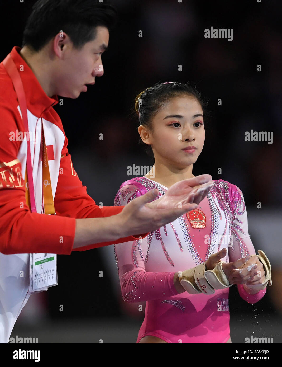 Stuttgart, Germany. 10th Oct, 2019. Chinese gymnast Li Shijia (R) receives  advices from her coach during the Women's All-Around Final of the 2019 FIG  Artistic Gymnastics World Championships in Stuttgart, Germany, Oct.
