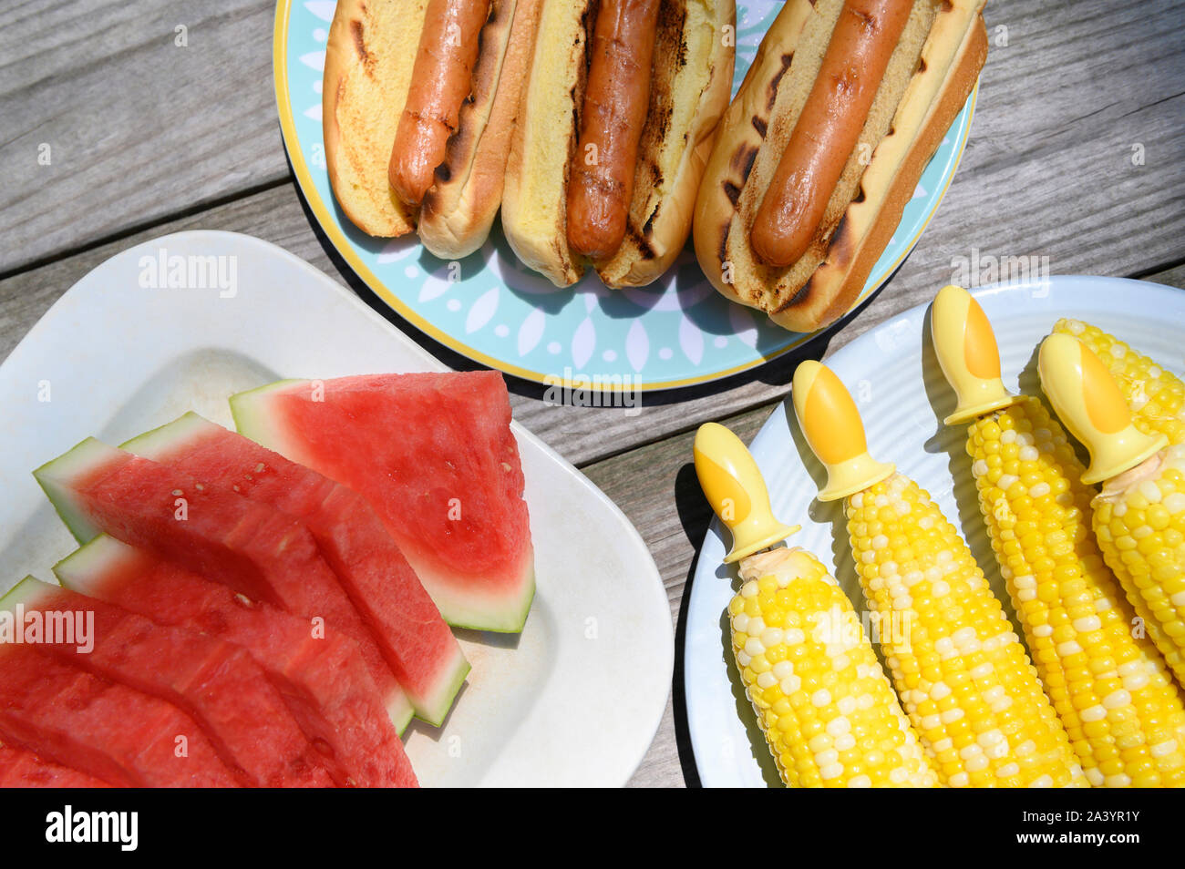 Watermelon, hot dogs and corn cobs Stock Photo