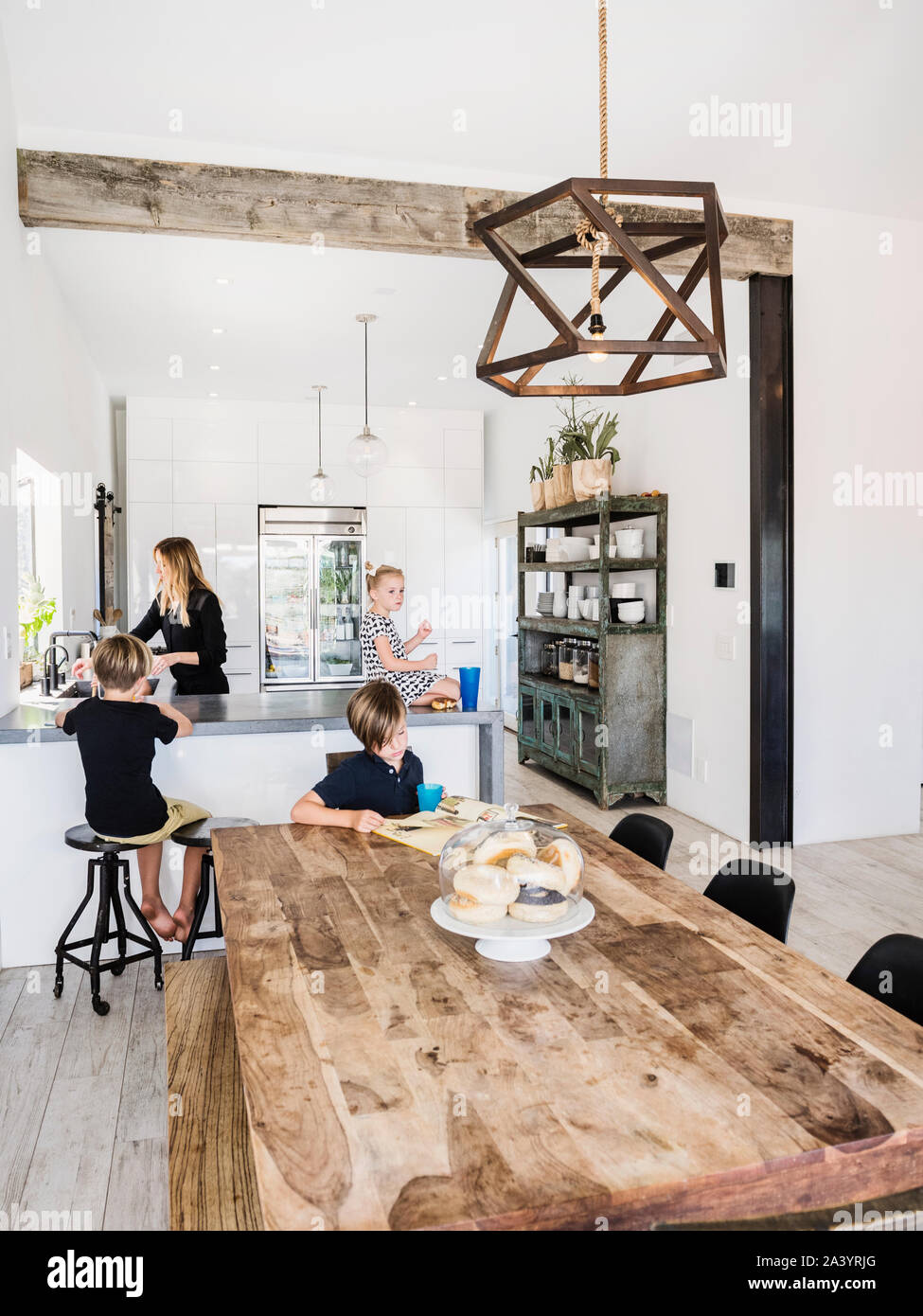 Mother and children in kitchen and dining room Stock Photo - Alamy