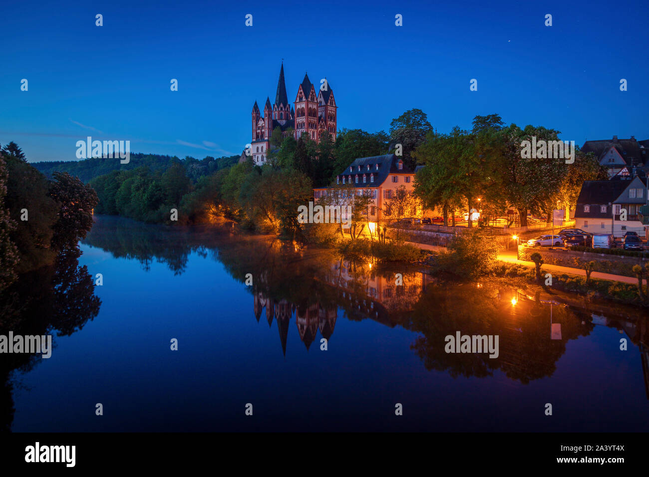 Limburg Cathedral by river at night in Limburg, Germany Stock Photo