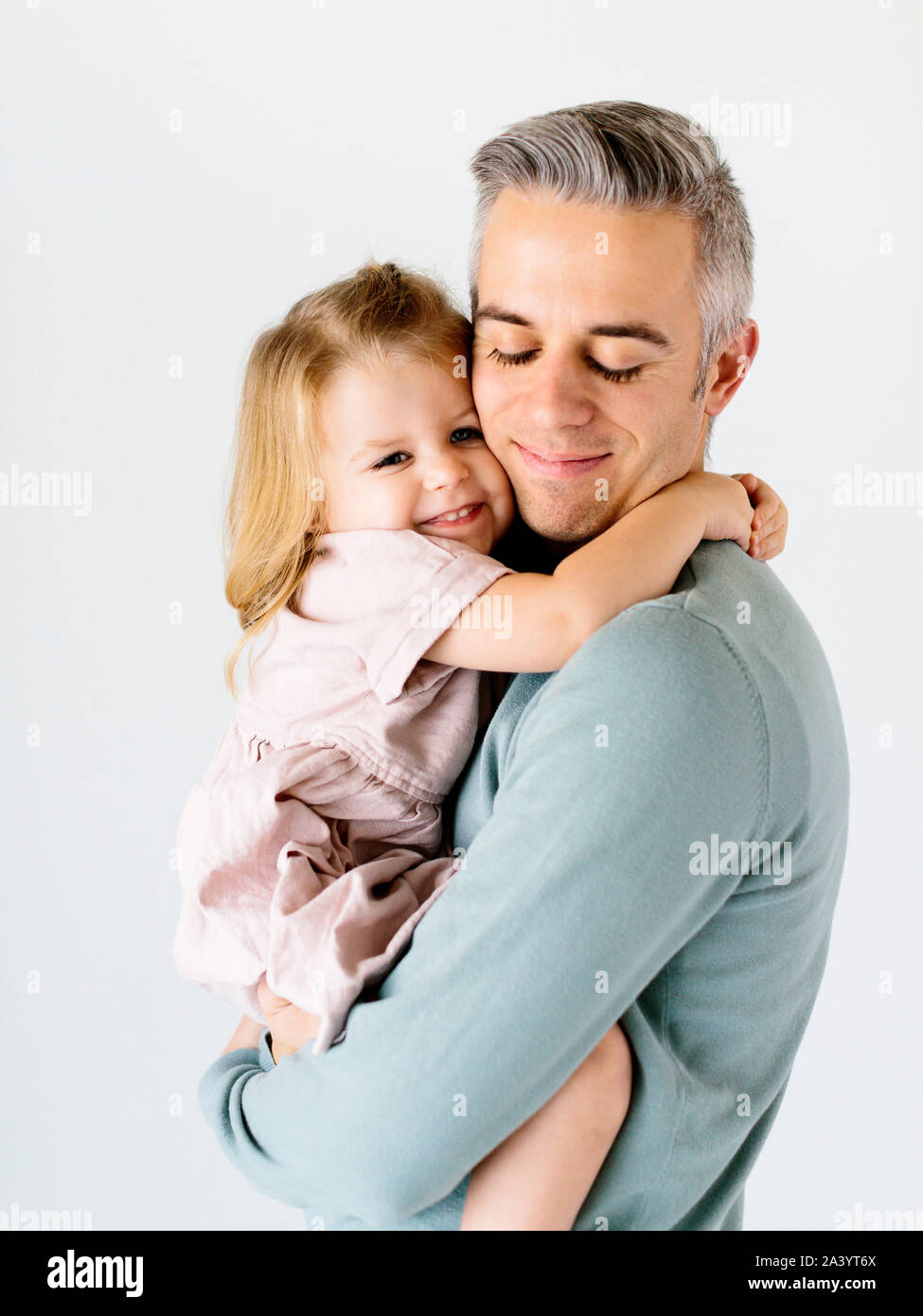 Smiling man holding his daughter Stock Photo