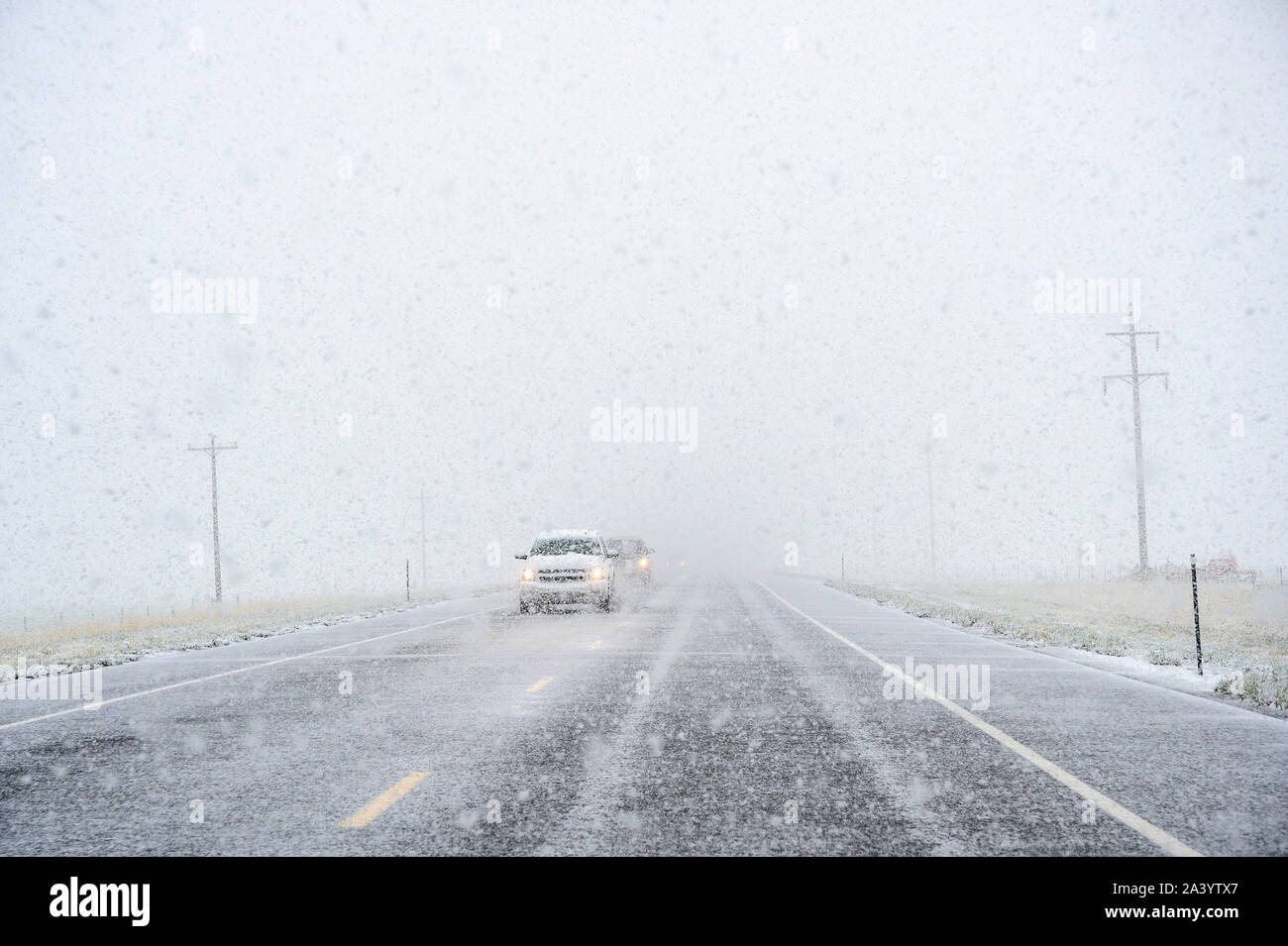 View through windscreen of car on highway during snow Stock Photo