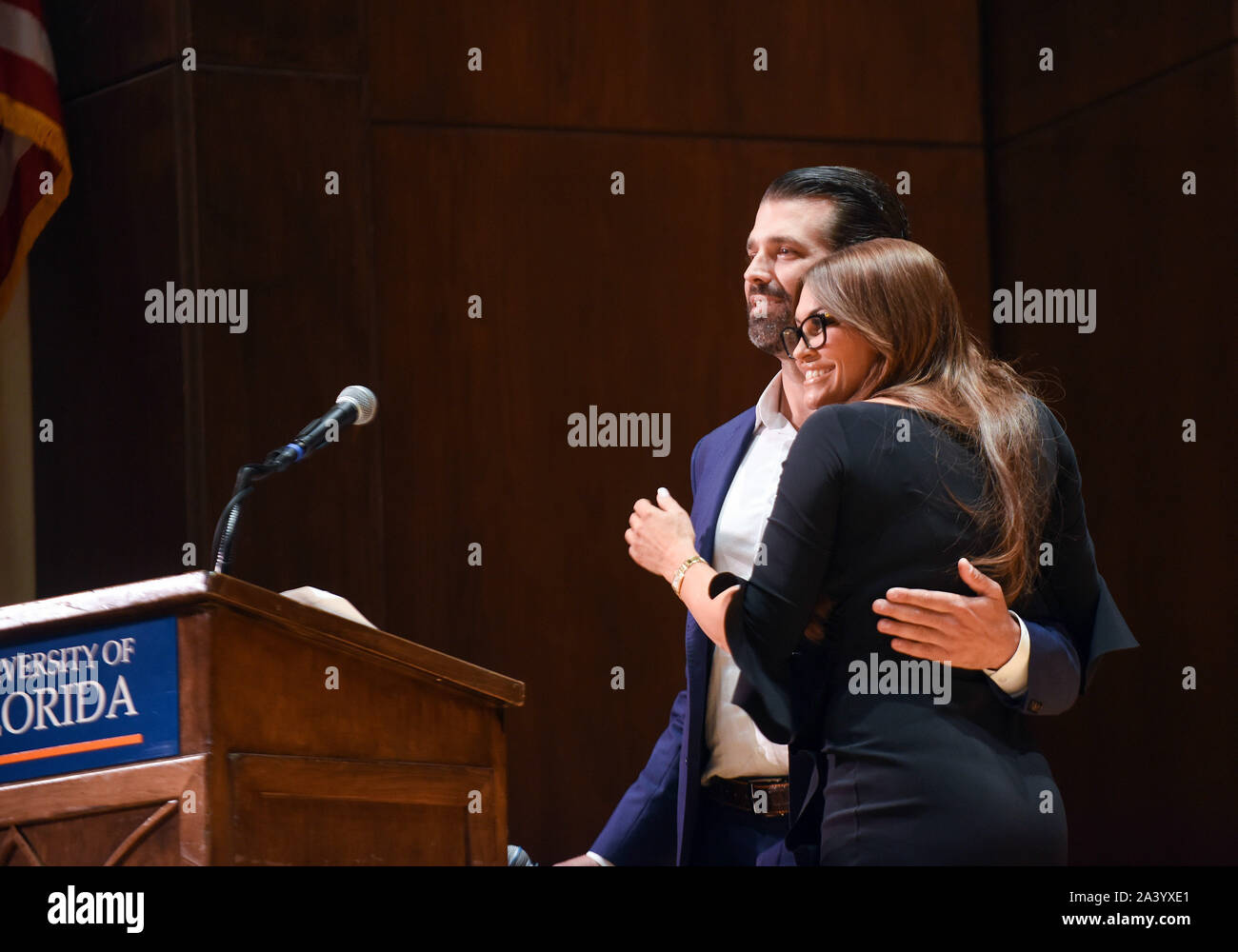 Gainesville, United States. 10th Oct, 2019. Donald Trump, Jr and his girlfriend, Kimberly Guilfoyle embrace each other during a speech at the University of Florida. Credit: SOPA Images Limited/Alamy Live News Stock Photo
