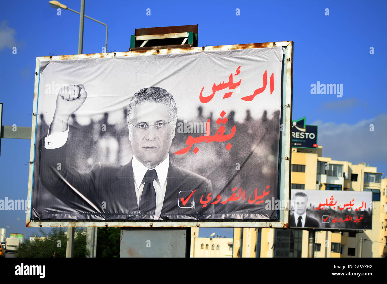 Tunis, Tunisia. 09th Oct, 2019. An electoral poster of Tunisian presidential candidate Nabil Karoui is pictured along the road in the capital Tunis. The slogan in Arabic reads: 'The president inside his heart'. Credit: SOPA Images Limited/Alamy Live News Stock Photo