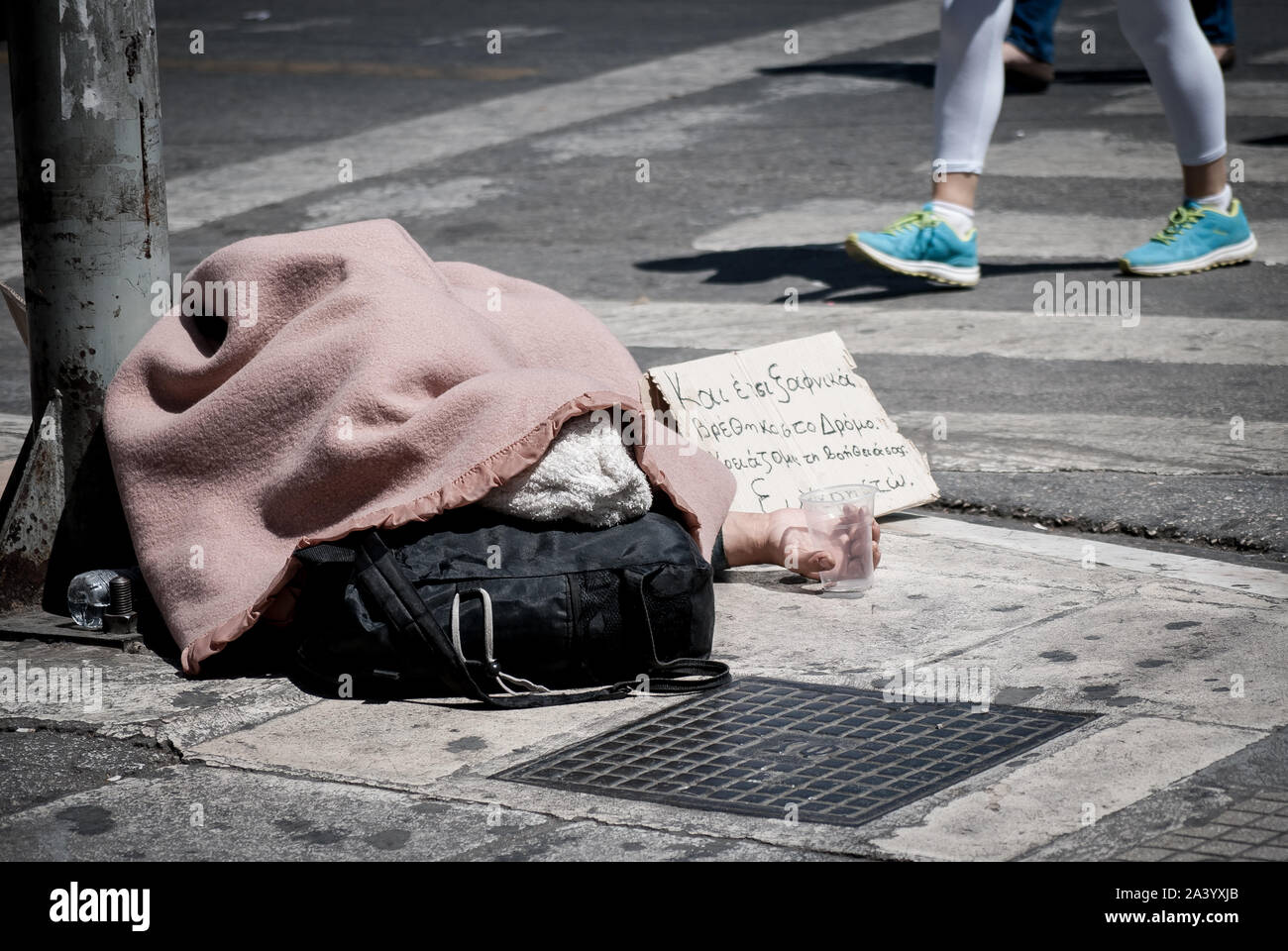 Athens, Greece. 10th Oct, 2019. A homeless person seen sleeping on the sidewalk.World Homeless Day was born out of discussions between aid workers around the world, all of whom were helping the homeless in their own countries. Credit: SOPA Images Limited/Alamy Live News Stock Photo