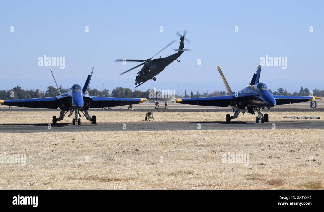 A California Air National Guard HH-60G Pavehawk Rescue Helicopter from the 129th Rescue Wing demonstrates combat maneuvers across from the U.S. Navy Blue Angel's staging area during the 2019 Capital Air Show at Mather Field, California Oct. 6, 2019. Multiple airframes from the California Air National Guard are participating in the airshow and demonstrating the Air National Guard's unique support capabilities available for statewide emergencies and civil agencies in addition to putting on a great show for airshow attendees. (U.S. Air National Guard photo by Tech. Sgt. Christian Jadot) Stock Photo