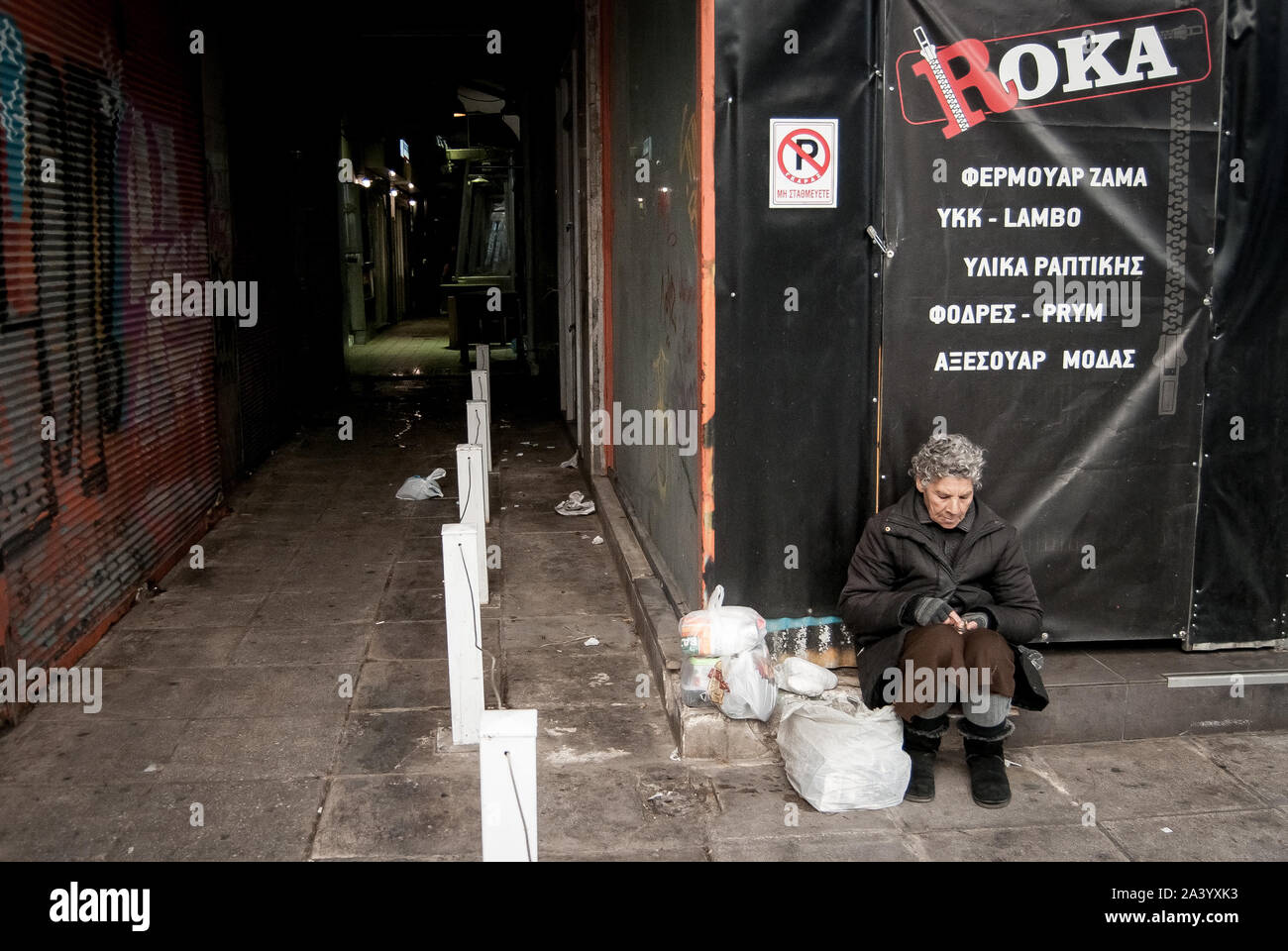 Athens, Greece. 10th Oct, 2019. A homeless person sits on the sidewalk.World Homeless Day was born out of discussions between aid workers around the world, all of whom were helping the homeless in their own countries. Credit: SOPA Images Limited/Alamy Live News Stock Photo