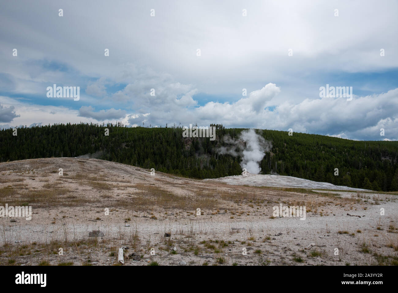 Old faithful geyser in Yellowstone national park steaming just before an eruption Stock Photo