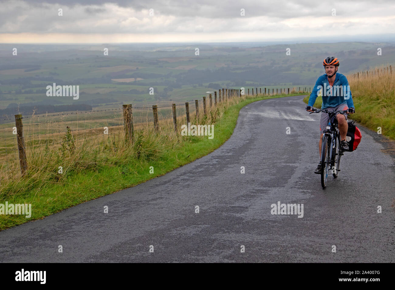 Cyclist climbing towards Hartside on the Coast to Coast cycle route Stock Photo