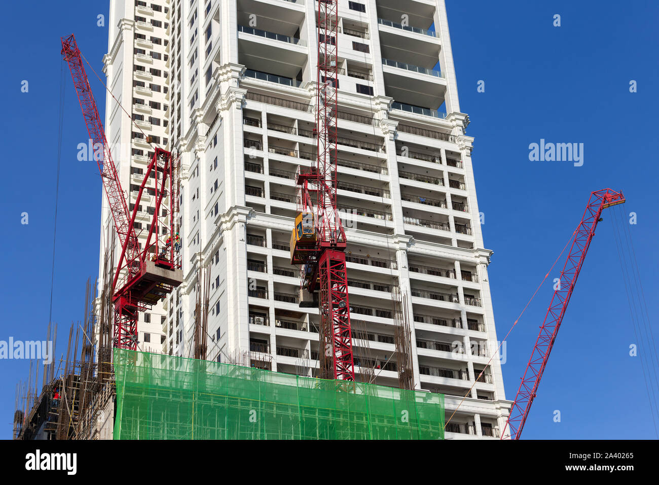 Manila, Philippines - May 16, 2017: Process of building, cranes at work on construction site Stock Photo