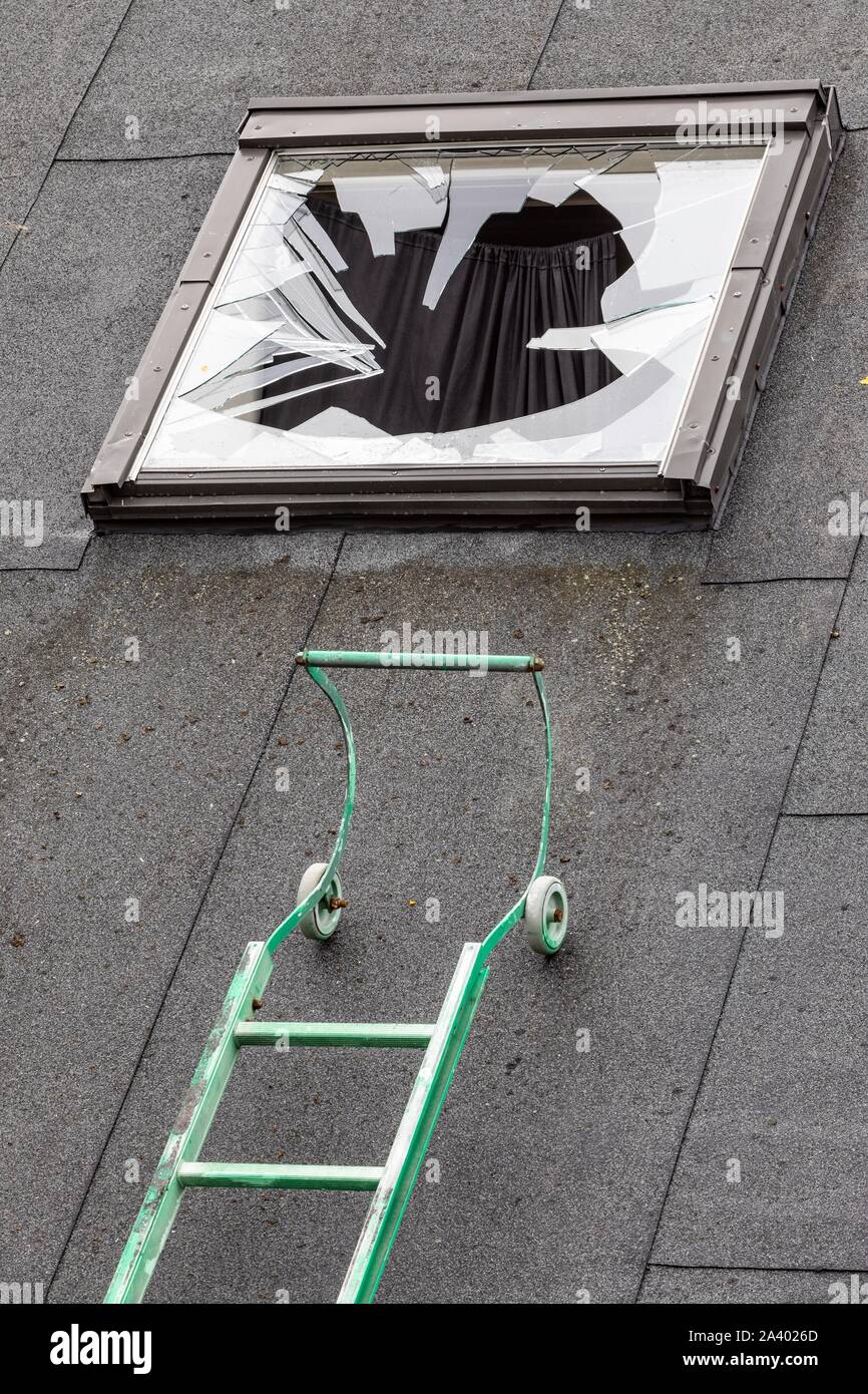 LADDER ON THE ROOF AND BROKEN SKYLIGHT FOLLOWING A BURGLARY Stock Photo