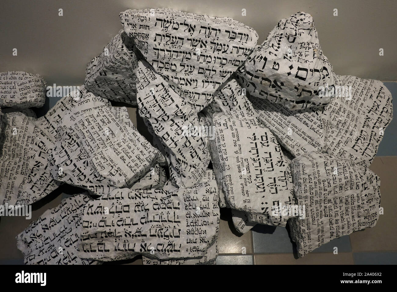 Artwork installation by artist Avner Sher of stones marked with biblical text in Hebrew which symbolize political violence part of an exhibition entitled Human Nature Shared Sensitivities, created for the 2019 Jerusalem Biennale for Contemporary Jewish Art, displayed in Heichal Shlomo the former seat of the Chief Rabbinate of Israel and currently a museum located adjacent to the Great Synagogue of Jerusalem, Israel Stock Photo