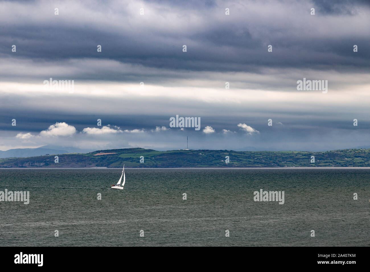 Yacht under sail at Moelfre, Anglesey, North Wales Stock Photo