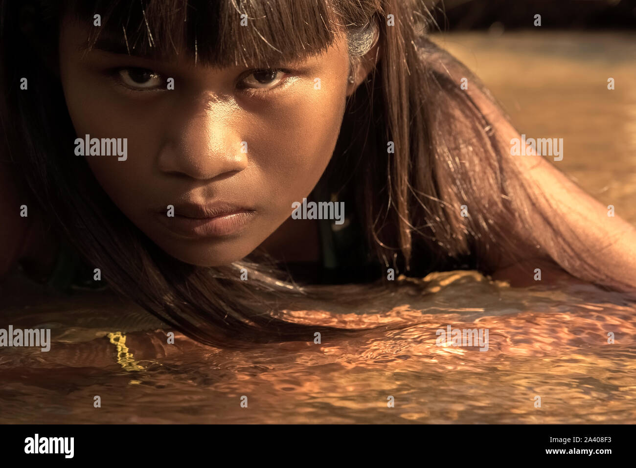 Natividade, Tocantins, Brazil - May 09, 2016: Indigenous Brazilian girl from Tocantins State laying on the river waters Stock Photo