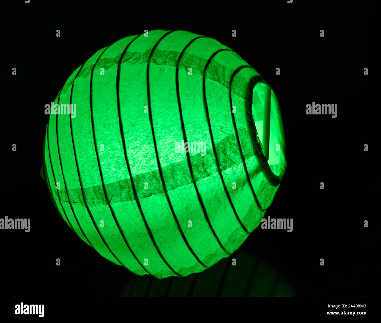 Bright Neon Flourophor Green Glow Stick Mini Chinese Lantern Isolated on Black Background Stock Photo