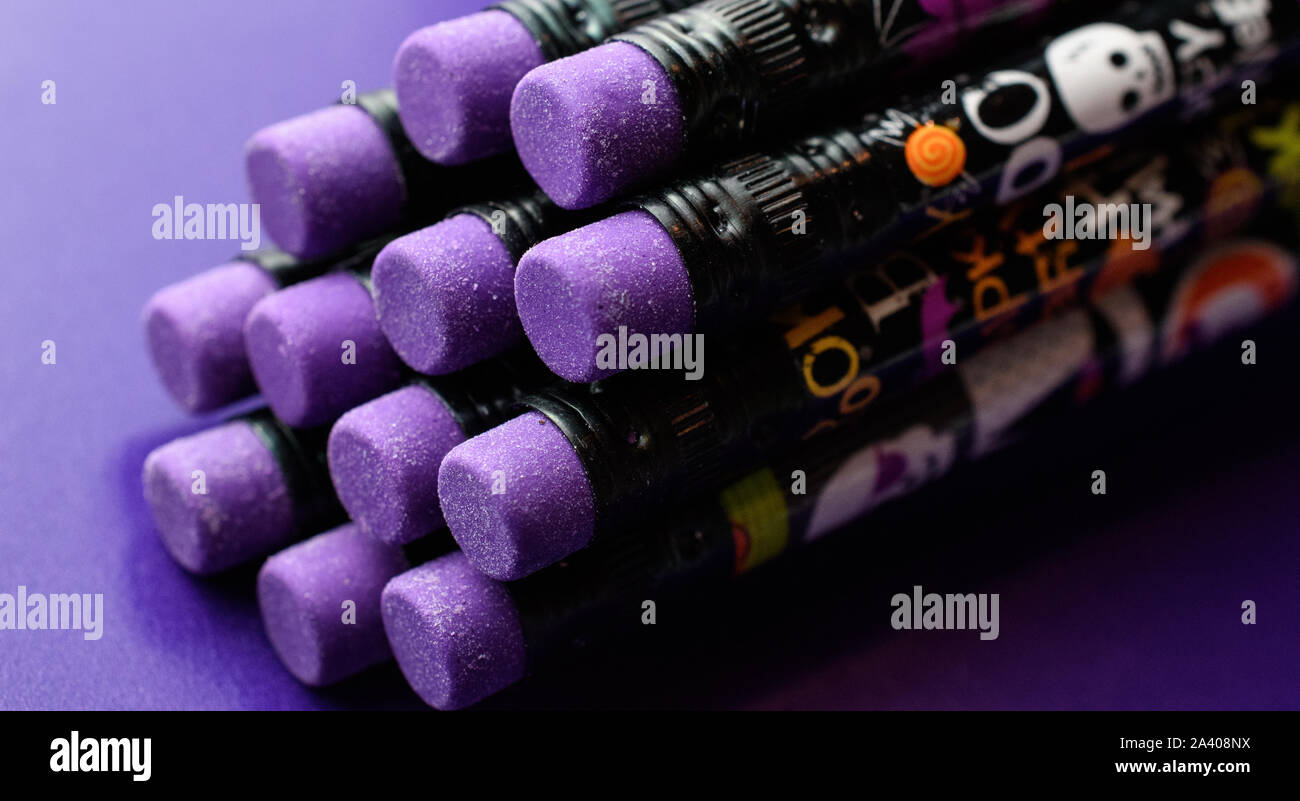 Closeup of Cool Halloween Pencils Showing Grainy Purple Eraser Heads Isolated on Purple Background Stock Photo