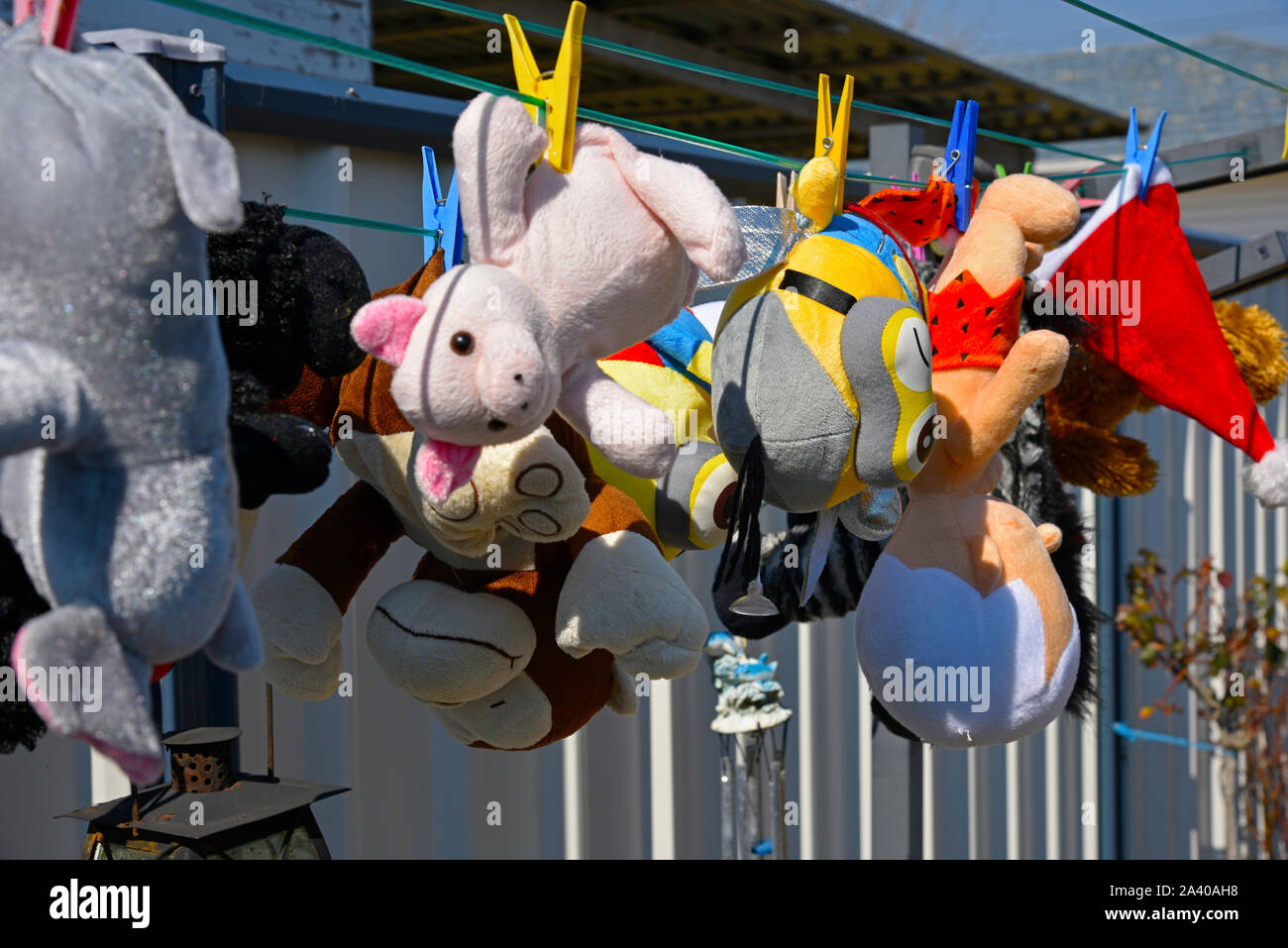 childrens toys hanging out to dry on a clothes line after washing Stock Photo