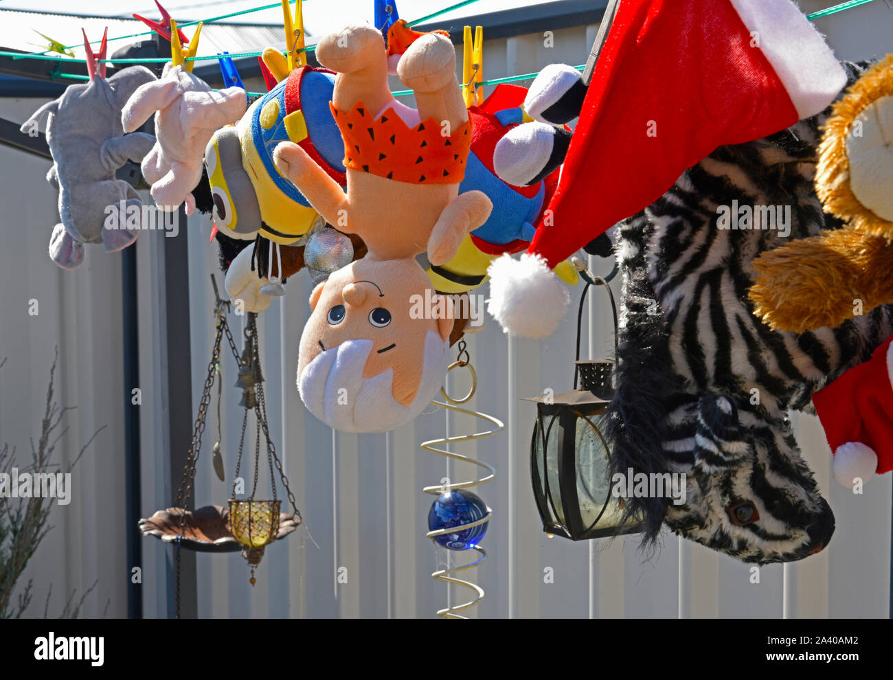 childrens toys hanging out to dry on a clothes line after washing Stock Photo