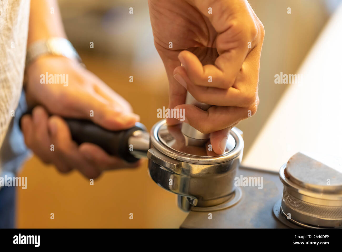 Step by step coffee making part four. Tamping the ground coffee in the