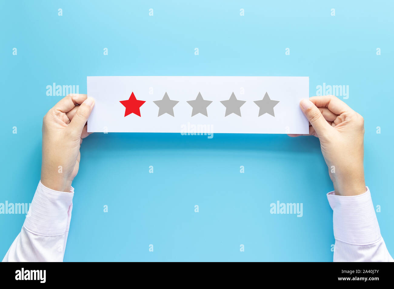 rating and feedback concept. customer holding paper with poor satisfied review by give one star for service experience Stock Photo