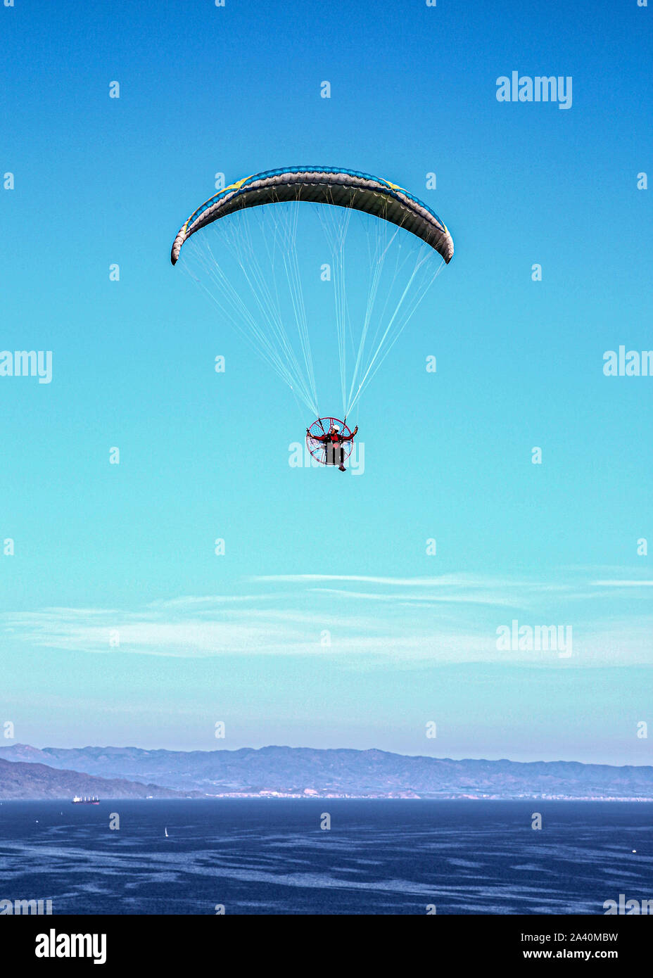 Paragliding over a Crystal Blue Sea Stock Photo - Alamy