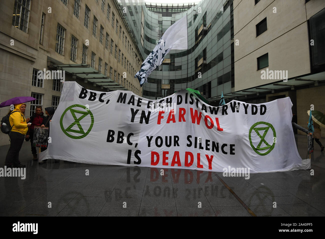 Protesters blocking the entrance to the BBC in London, during an Extinction Rebellion (XR) protest. Stock Photo