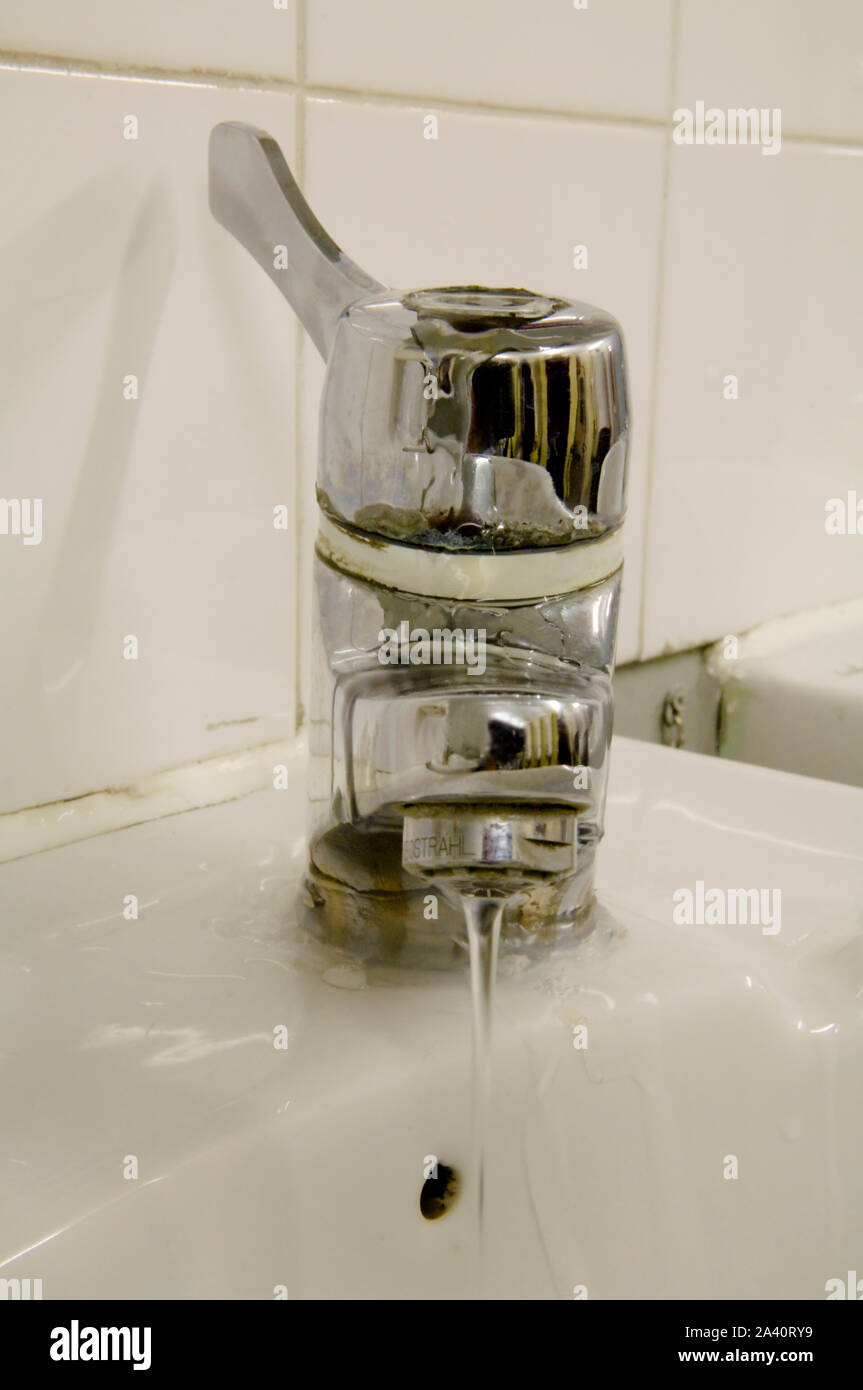 Dirty leaking mixer tap, leaking water and a waste to the environment Stock Photo Alamy