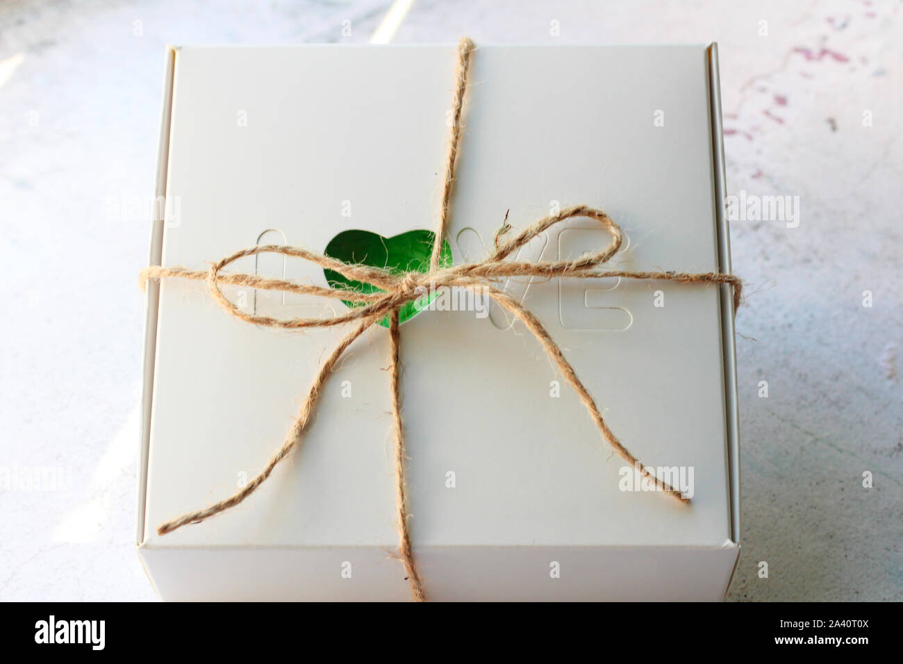 white cardboard box with the word love tied up with a rope Stock Photo Alamy