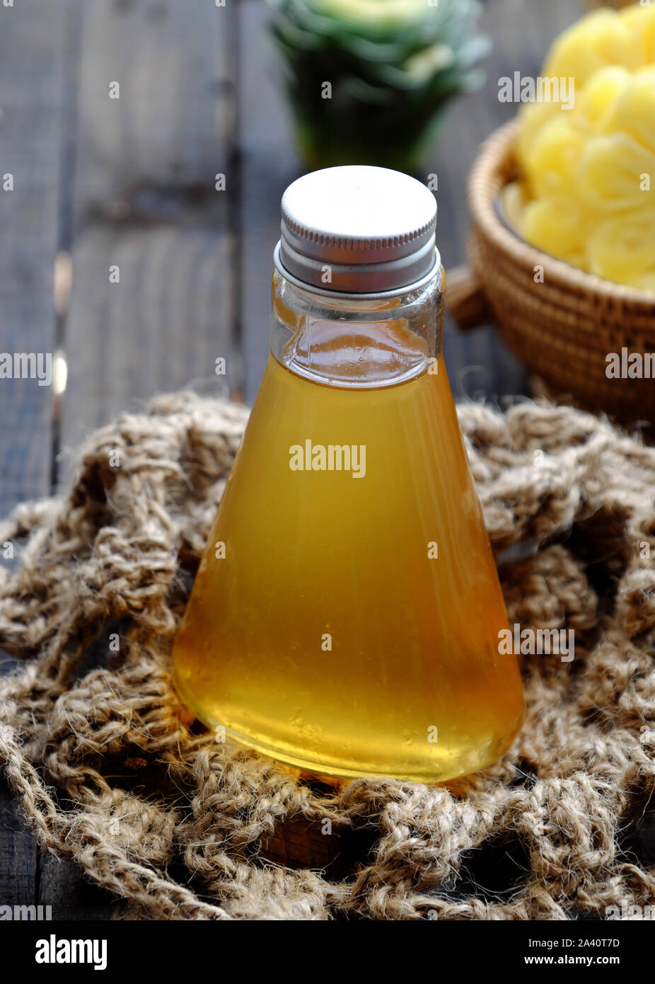 Close up vegan dipping sauces bottle from pineapple slices with salt for Vietnamese vegetarian cuisine on black wooden background Stock Photo