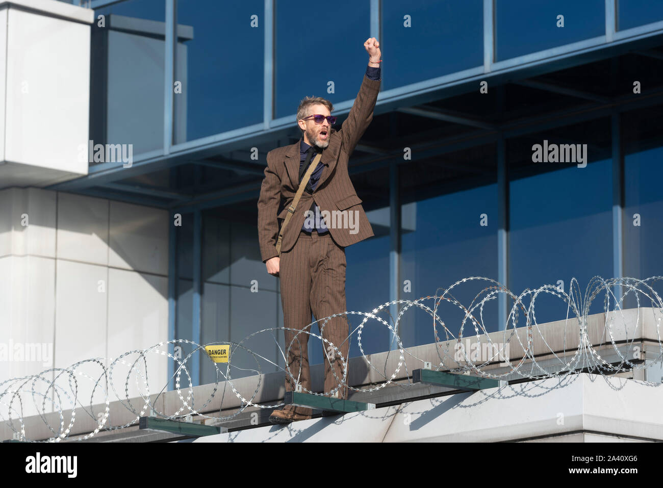 London, Britain. 10th Oct, 2019. An Extinction Rebellion protestor demonstrates at City Airport in London, Britain, on Oct. 10, 2019. Credit: Ray Tang/Xinhua/Alamy Live News Stock Photo