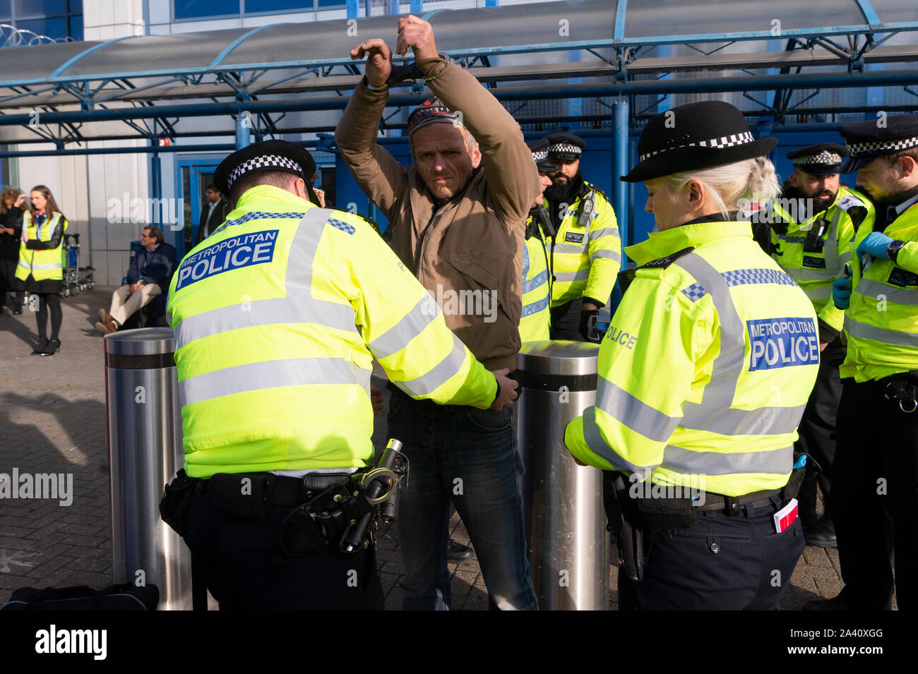 London, Britain. 10th Oct, 2019. An Extinction Rebellion protestor is arrested by police at City Airport in London, Britain, on Oct. 10, 2019. Credit: Ray Tang/Xinhua/Alamy Live News Stock Photo